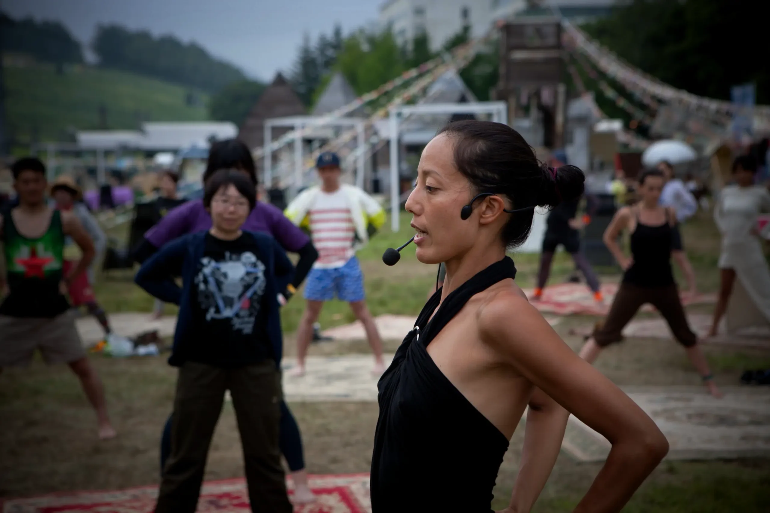 Photograph of Satoko Horie teaching a seminar to a group of participants outdoors.