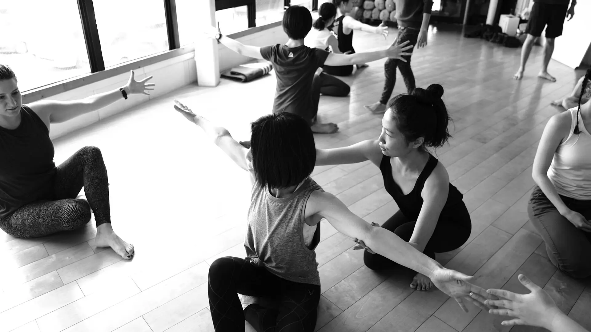 People are working together in pairs at a Baseworks event in a bright room with big windows