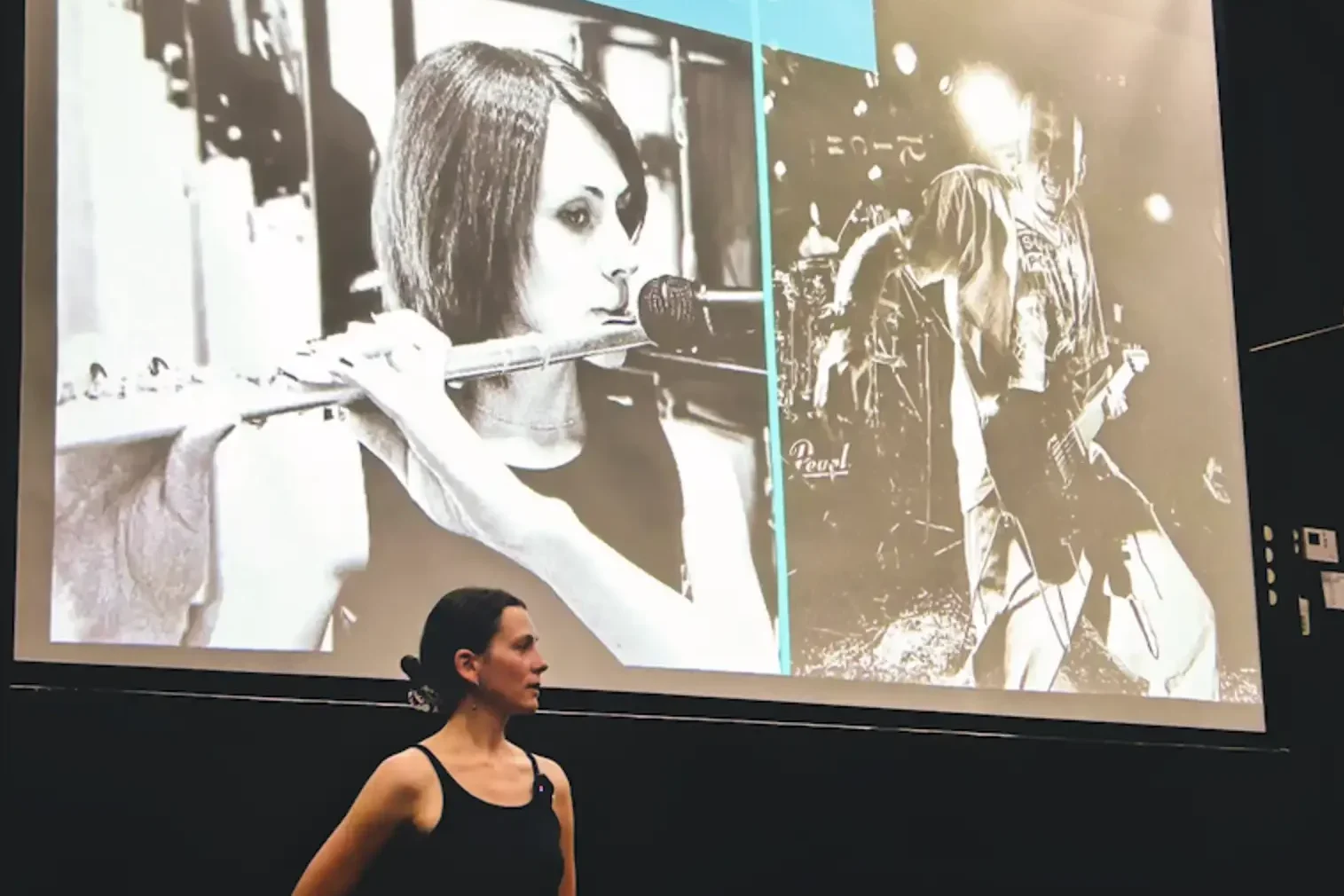 The instructor in front of a big screen with a projection of her presentation overhead.