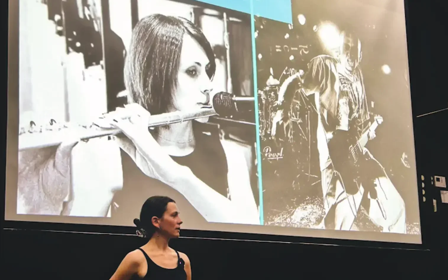 The instructor in front of a big screen with a projection of her presentation overhead.