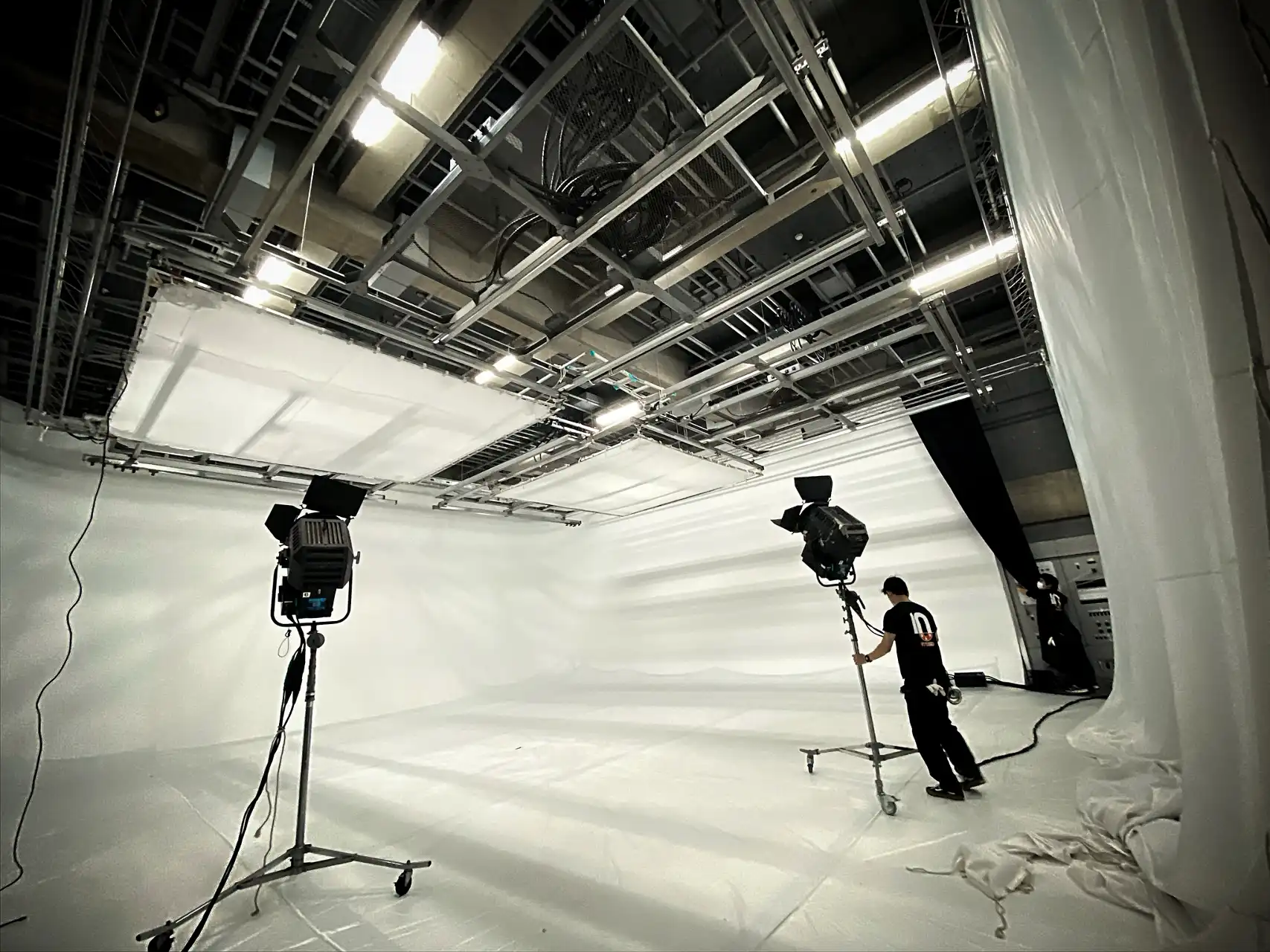 the studio technicians in a white room setting the lighting