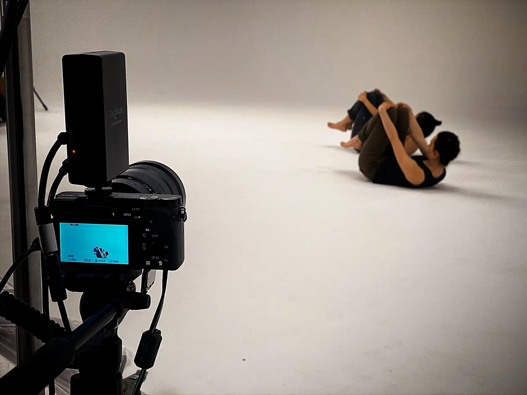 a camera view finder showing and a satoko and asia lying on the floor