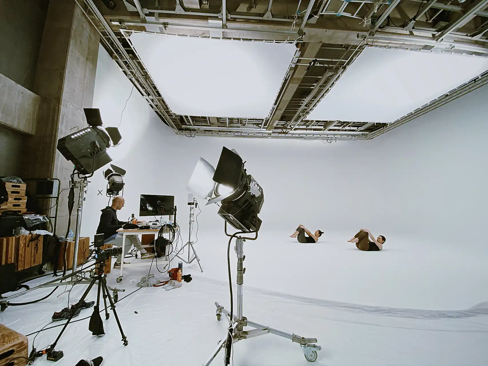 the production crew in the studio including patrick at the desk editing and satoko and asia modelling the practice forms