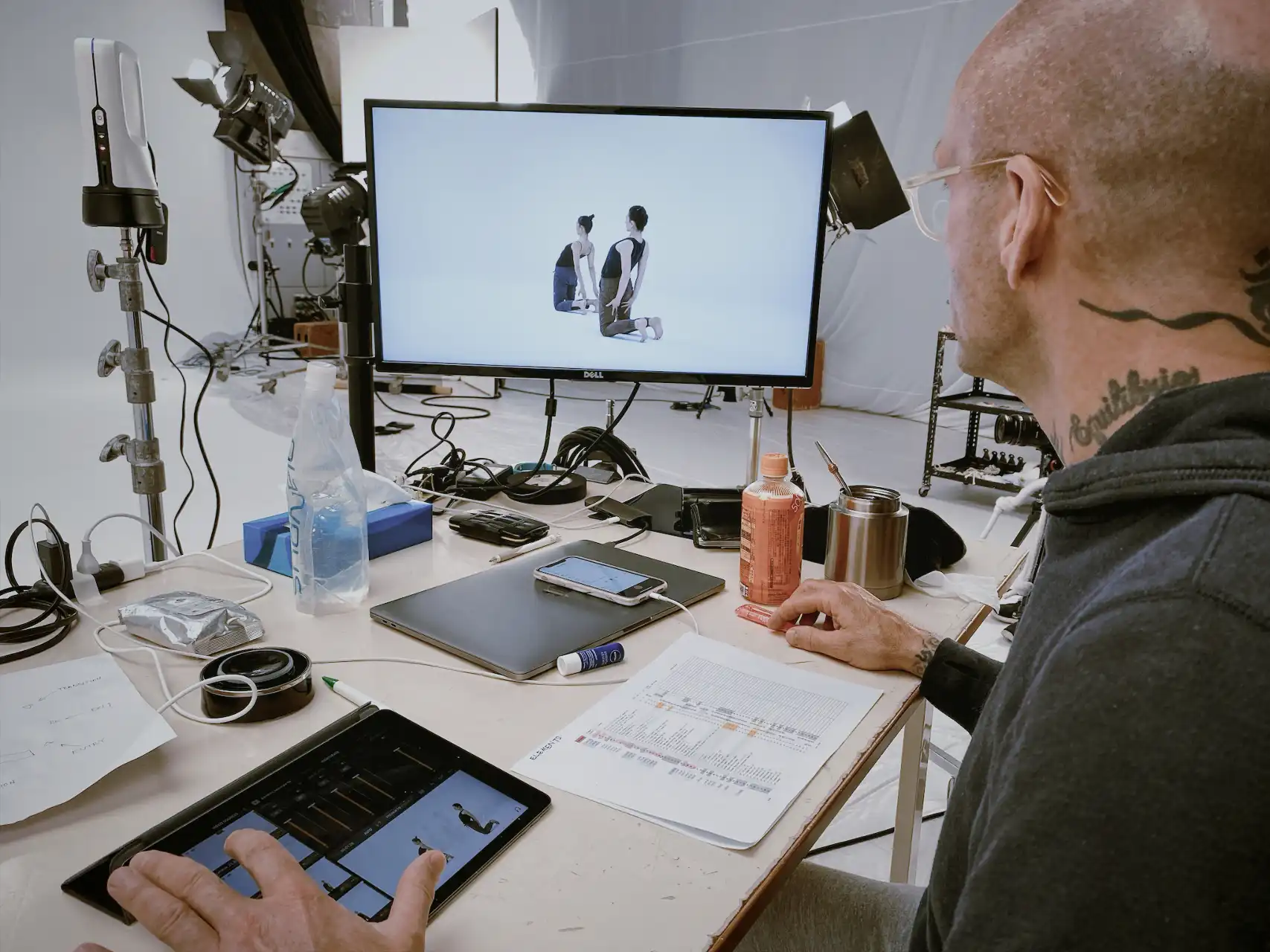 Patrick editing camera angles while sitting at a desk with a computer