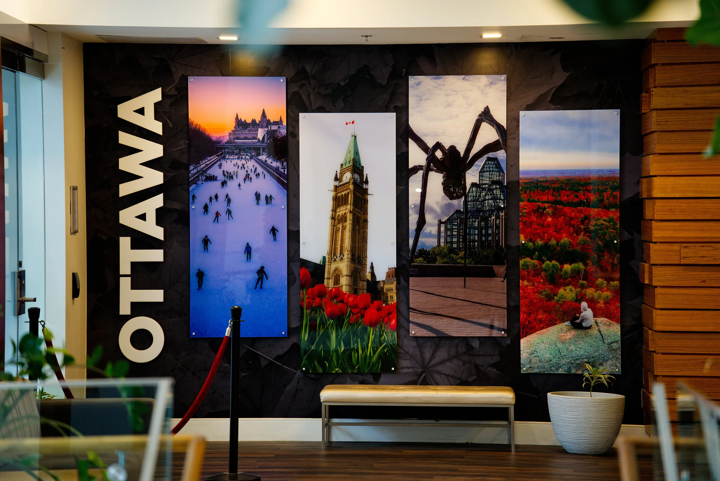A wall mural spelling OTTAWA beside photographs of the city, in the lobby of the Delta Hotels Ottawa City Centre, where SCAPPS 2026 took place.