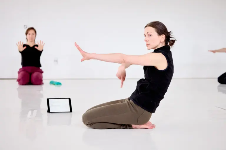 A participant kneeling and demonstrating an arm position during a Baseworks Winter 2026 Study Group session in Montreal